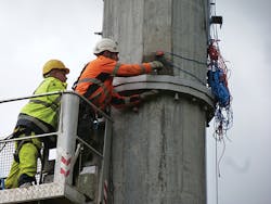 Erecting and bolting flanges of sections of composite pole. Erecting and bolting flanges of sections of composite pole.