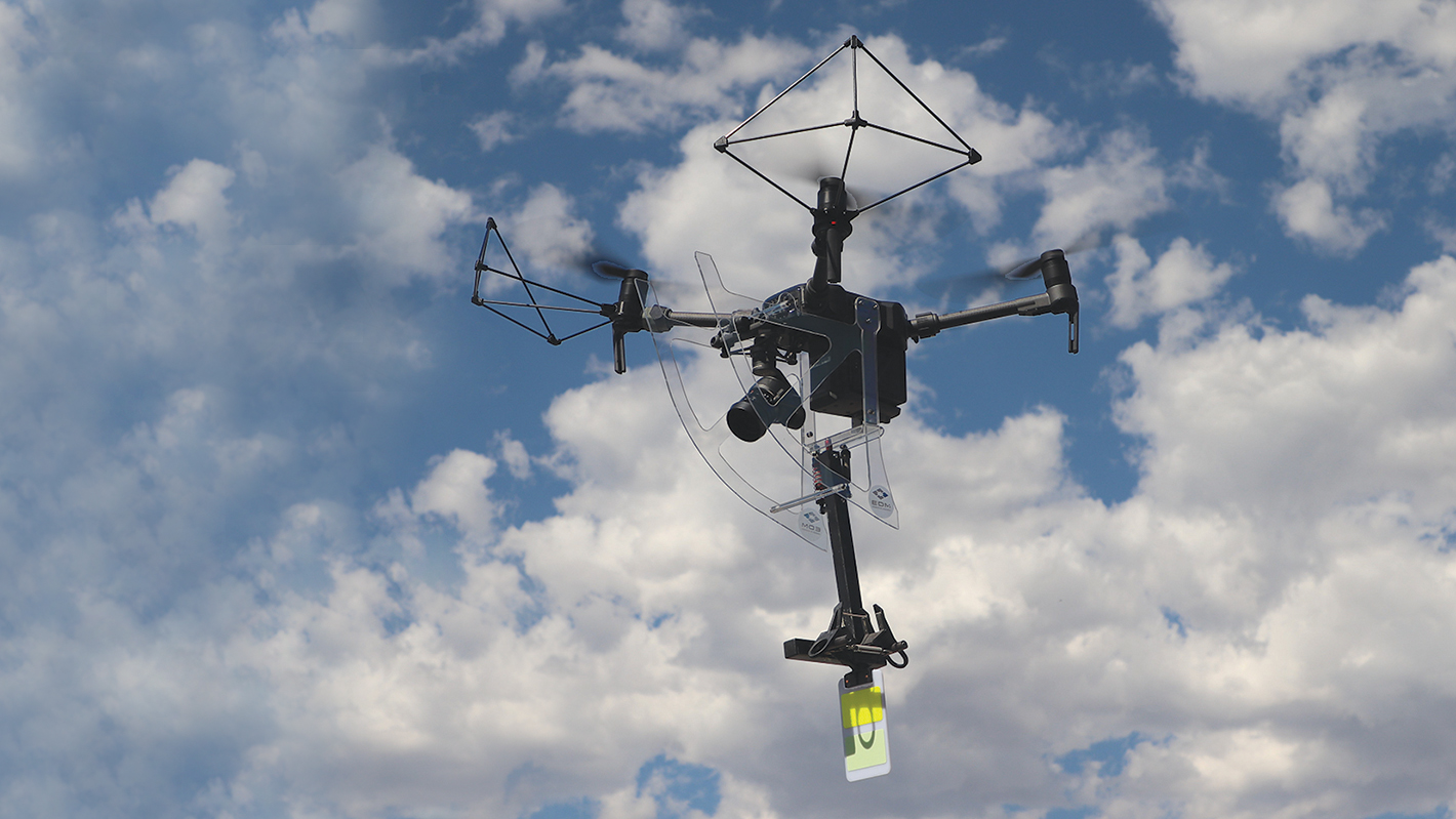Close-up of UAS in flight with line marker.