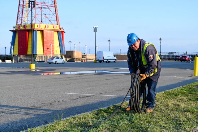 Con Edison&rsquo;s emergency operations supervisor Al Marchione rolling out the cable that will be installed to feed the temporary shed to power Coney Island Hospital MCU Park Brooklyn.