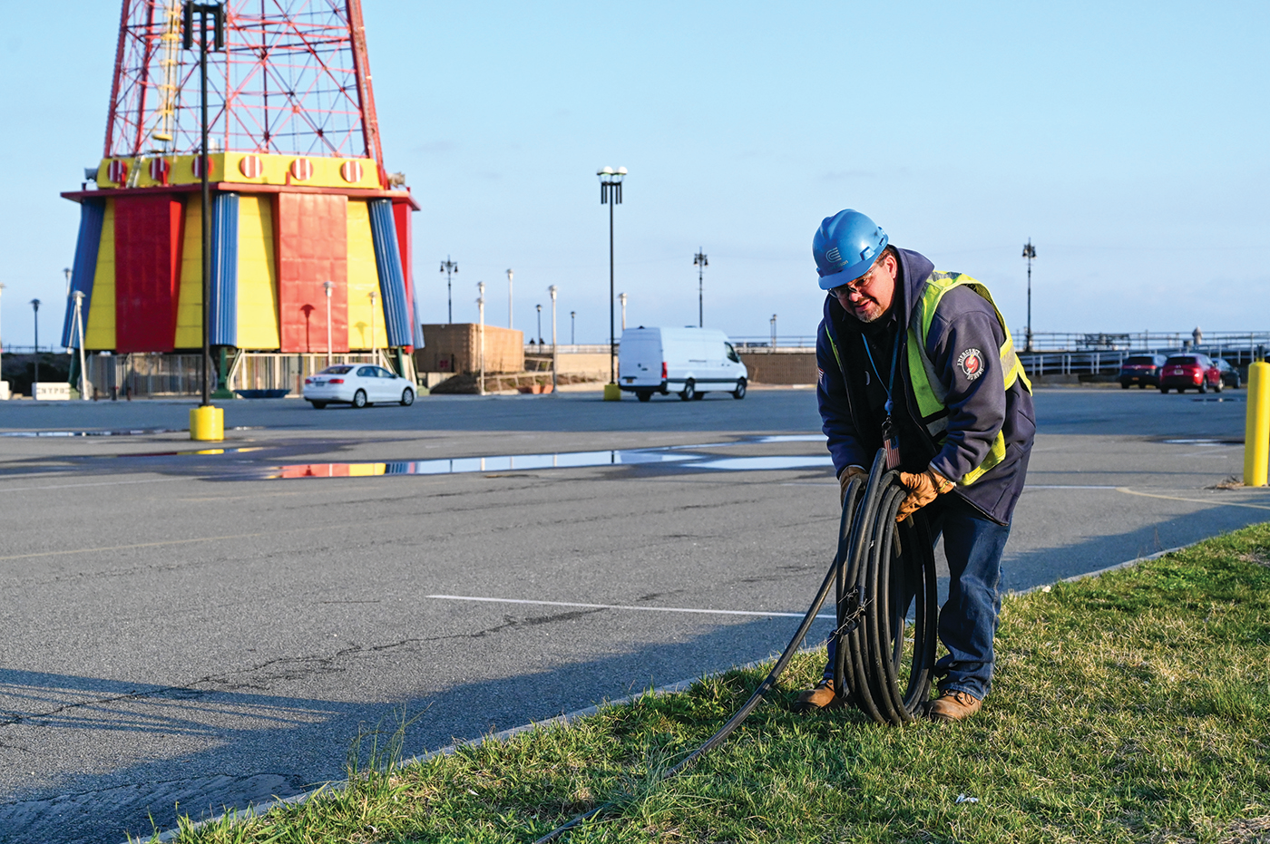 Con Edison's emergency operations supervisor Al Marchione rolling out the cable that will be installed to feed the temporary shed to power Coney Island Hospital MCU Park Brooklyn.