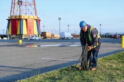 Con Edison's emergency operations supervisor Al Marchione rolling out the cable that will be installed to feed the temporary shed to power Coney Island Hospital MCU Park Brooklyn. Con Edison's emergency operations supervisor Al Marchione rolling out the cable that will be installed to feed the temporary shed to power Coney Island Hospital MCU Park Brooklyn.