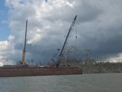 After locating a downed transmission tower in the Cumberland River, crews used cranes mounted on a barge to remove the twisted metal from the river.