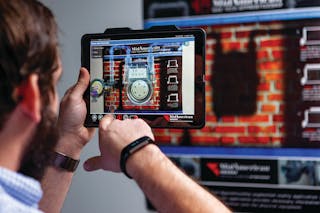 Worker uses a tablet-based app to visualize gas meter internals.