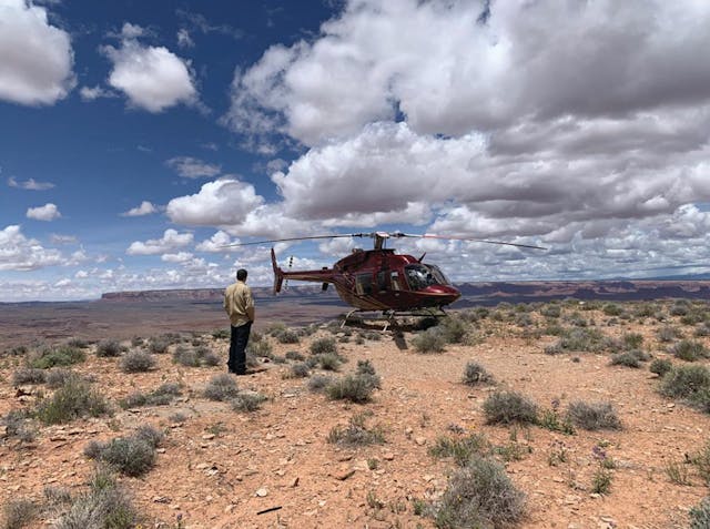 A transmission lines aerial observer and fully equipped helicopter operates in the Desert Southwest.