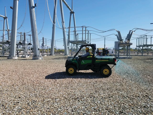 Contract bare ground treatment sprayers work in a substation.