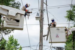 Contractors with Entergy Arkansas work to restore power near the First Baptist Church in Smackover, Arkansas, on April 14, 2020.