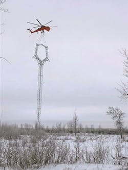 Tower erection of guyed structure using sky crane helicopter.