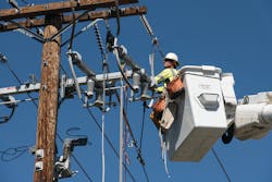 A Southern California Edison lineman is in a bucket truck installing covered conductor around distribution equipment. Covered conductors are a critical aspect to wildfire mitigation work. A Southern California Edison lineman is in a bucket truck installing covered conductor around distribution equipment. Covered conductors are a critical aspect to wildfire mitigation work.