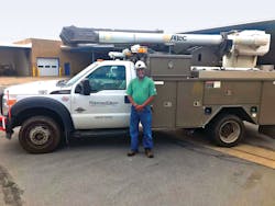 Conrad Myers, Line Troubleshooter for Potomac Edison, stands in front of his truck at the Potomac Edison Headquarters in Williamsport, Maryland. He has been with the company for 29 years.