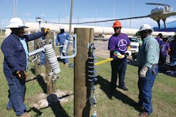 Duke Energy Youth Energy Academy participants learn lineman work at ground level. Even with the advantage of having both feet on the ground, working with tools while wearing gloves is a lot harder than it looks.
