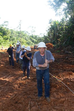 Teter and several other linemen hand pull the wire. Teter and several other linemen hand pull the wire.