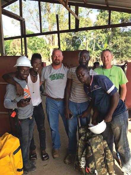 Jeremy Wooden and Jason Toalson worked alongside the local cooperative&rsquo;s new linemen to build a power line in Liberia.