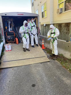 Eversource contractors in their PPE preparing to do an in-person energy assessment.