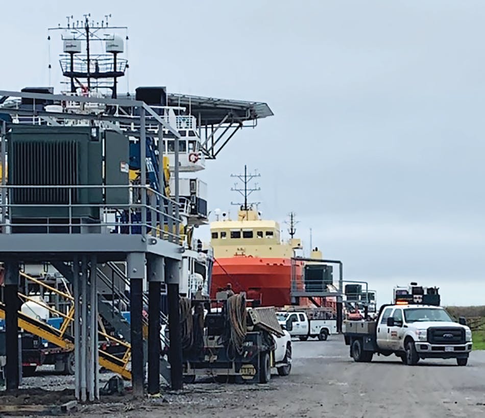 An ECO vessel tied to an Entergy shore power platform with electrical service buried underground to ensure the safe movement of cranes and other industrial equipment at Port Fourchon, Lafourche Parish.