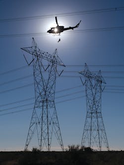 SRP line workers are lowered onto energized towers by helicopter and climb down 150 ft to ground while inspecting for defects and damage. SRP line workers are lowered onto energized towers by helicopter and climb down 150 ft to ground while inspecting for defects and damage.