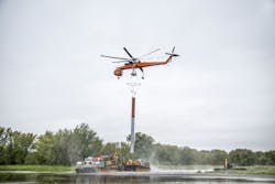 Helicopter transport and marsh equipment assist installation of vibratory caissons in open water locations. Helicopter transport and marsh equipment assist installation of vibratory caissons in open water locations.