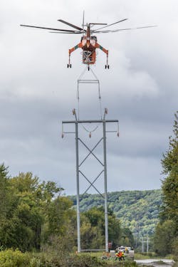 Aerial teams set a structure on the helical pile and grillage foundations. Accuracy above and below is essential with helicopter installation of the steel H-frames into the helical pile and grillage foundations. Temporary guides placed on the foundations assist with proper alignment. Aerial teams set a structure on the helical pile and grillage foundations. Accuracy above and below is essential with helicopter installation of the steel H-frames into the helical pile and grillage foundations. Temporary guides placed on the foundations assist with proper alignment.
