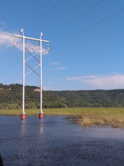 Completed H-frame on caisson foundations shown during conductor installation. Completed H-frame on caisson foundations shown during conductor installation.