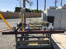 Phase-to-phase contact with vegetation on covered conductor, energized at 12 kV. Current was measured at 0.001 mA. Phase-to-phase contact with vegetation on covered conductor, energized at 12 kV. Current was measured at 0.001 mA.