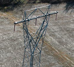 Aerial photo of the lattice tower with crossarm in bending. Aerial photo of the lattice tower with crossarm in bending.