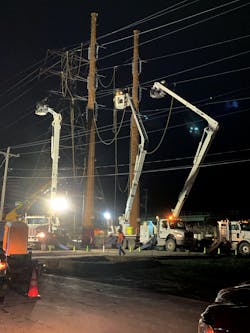 Working through the night to minimize disruption across a state highway crossing, Three Phase Line crews transfer a conductor from an old structure (in the background, to a new one in the foreground). Working through the night to minimize disruption across a state highway crossing, Three Phase Line crews transfer a conductor from an old structure (in the background, to a new one in the foreground).