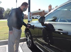 Dr. Rob Keynton, dean of the William States Lee College of Engineering, connects his plug-in hybrid electric vehicle to a Pole Volt charger (background) as part of early testing before a year-long public trial in Charlotte, North Carolina. Dr. Rob Keynton, dean of the William States Lee College of Engineering, connects his plug-in hybrid electric vehicle to a Pole Volt charger (background) as part of early testing before a year-long public trial in Charlotte, North Carolina.