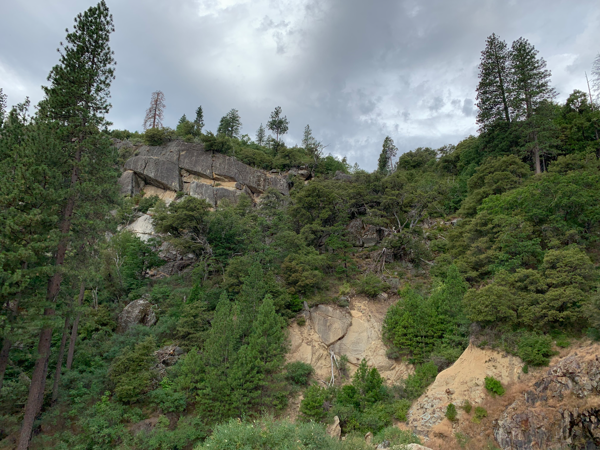 This rockfall hazard right above an access road presents both direct and indirect potential liability. An access road blocked by large boulders could inhibit inspections and interfere with emergency response.