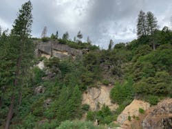 This rockfall hazard right above an access road presents both direct and indirect potential liability. An access road blocked by large boulders could inhibit inspections and interfere with emergency response. This rockfall hazard right above an access road presents both direct and indirect potential liability. An access road blocked by large boulders could inhibit inspections and interfere with emergency response.