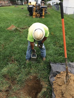 Contractor monitors underground cable pull. Contractor monitors underground cable pull.