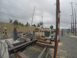 In this downed wire test, a simulated wire touches dry grass. The REFCL system can reduce current in microseconds so the wire is not hot enough to spark the dry grass. Courtesy of SCE. In this downed wire test, a simulated wire touches dry grass. The REFCL system can reduce current in microseconds so the wire is not hot enough to spark the dry grass. Courtesy of SCE.