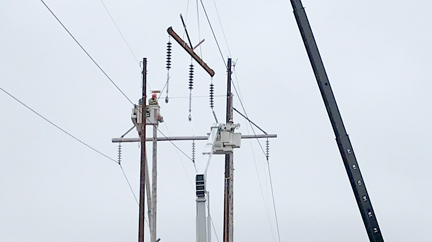Using the barehand method, Three Phase Line Construction crews have set two new steel poles. They are also working to install a steel cross arm for one of the new H-frame structures on Eversource's 1465 Line in Connecticut.