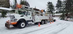 A Portland General Electric line truck and other equipment stands ready to assist with outage restoration. A Portland General Electric line truck and other equipment stands ready to assist with outage restoration.