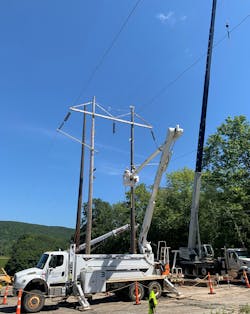 Three Phase Line Construction line workers undertake make-ready work on a conductor as part of setting a new H-frame structure. Three Phase Line Construction line workers undertake make-ready work on a conductor as part of setting a new H-frame structure.