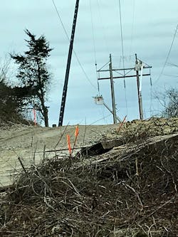 Three Phase Line Construction crews transfer an energized conductor from a wooden H-frame to a new, adjacent steel structure using the bare-hand method. Three Phase Line Construction crews transfer an energized conductor from a wooden H-frame to a new, adjacent steel structure using the bare-hand method.