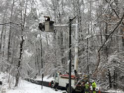 A lineworker restores power in Carroll County, Virginia. A lineworker restores power in Carroll County, Virginia.