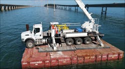 The Terex -125 Aerial barehand truck is stabilized and secured on the barge. The Terex -125 Aerial barehand truck is stabilized and secured on the barge.