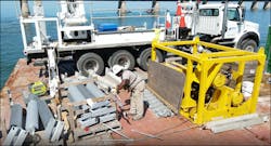 A barehand crew member prepares new hardware and polymer for overhead installation. A barehand crew member prepares new hardware and polymer for overhead installation.