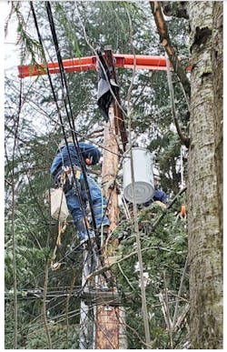 Line workers for Portland General Electric repair power distribution equipment damaged in SW Portland, Oregon. Line workers for Portland General Electric repair power distribution equipment damaged in SW Portland, Oregon.