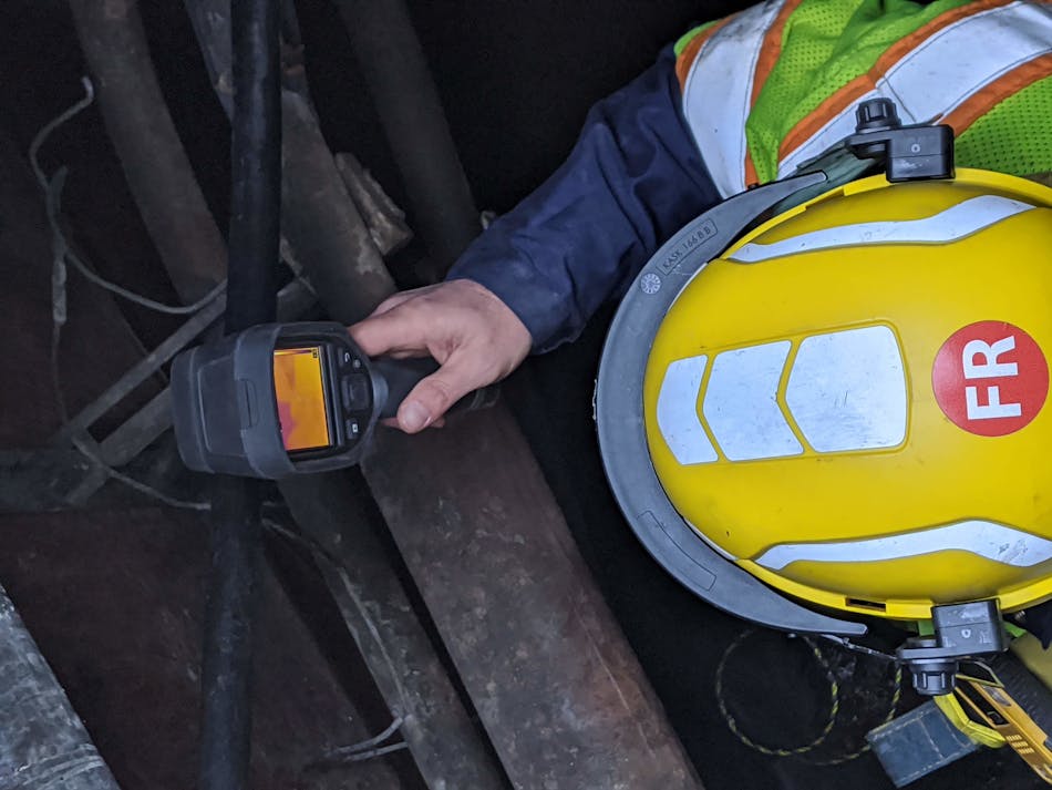 A manhole entrant performs a thermographic and visual assessment of the space to detect any hot spots or other abnormal conditions.