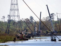 Swampy conditions in Louisiana called for specialized restoration equipment, including tracked swamp vehicles, barges, and fan boats.