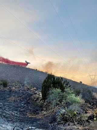 Aerial retardant drop is observed over WAPA&rsquo;s 230kV powerline.