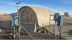 Quonset huts at NREL replicate military microgrid environments so that DOD and partners can reliably evaluate energy security with renewables and battery storage.
