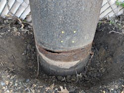 Jogging Trail: Corrosion damage has left a steel pole structurally compromised. Jogging Trail: Corrosion damage has left a steel pole structurally compromised.
