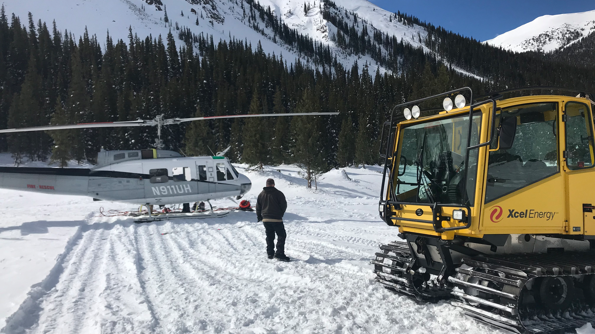 Snowcat and Huey helicopter for site access.