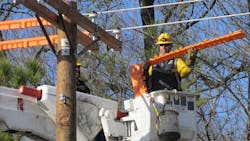 SMECO line workers, prior to beginning a job, performing cover-up work on conductors to create a barrier against the flow of electrical current. SMECO line workers, prior to beginning a job, performing cover-up work on conductors to create a barrier against the flow of electrical current.