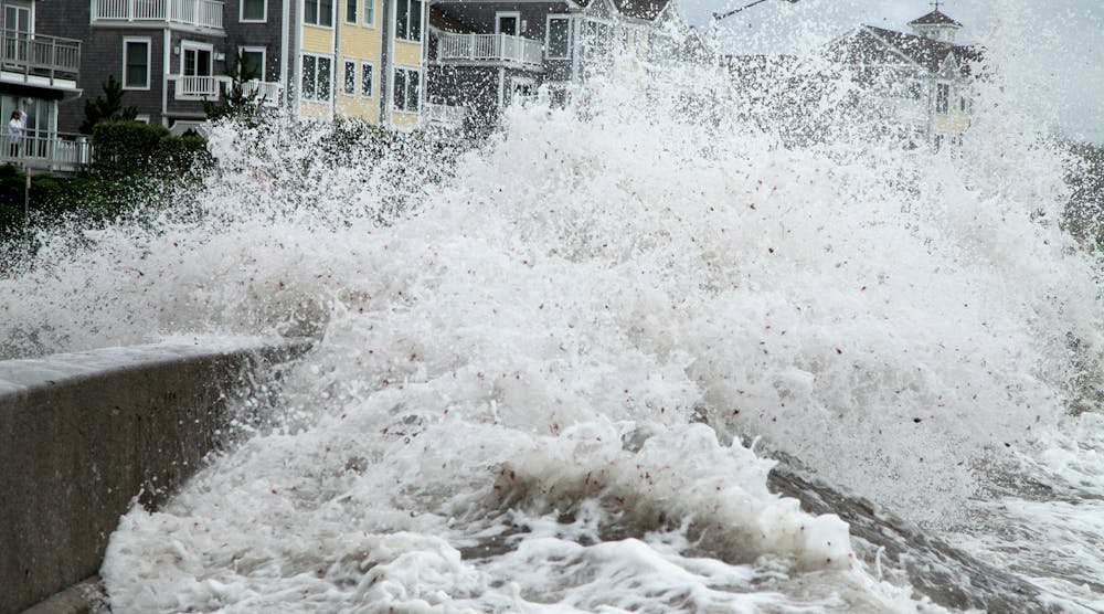 Waves breach a seawall during Hurricane Irene