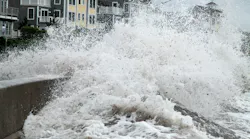 Waves breach a seawall during Hurricane Irene