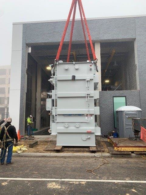 In order to install the 160,000-pound transformers, crews constructed a cribbed rail system to lower the transformers from the street into the bays, which are located four feet below street level. After the transformers were slid into the bay, gantries, located in the bay, were used to lift and slowly lower the transformer as the rails and cribbing were removed. Finally, the transformers were spun into final orientation using a milling plate.