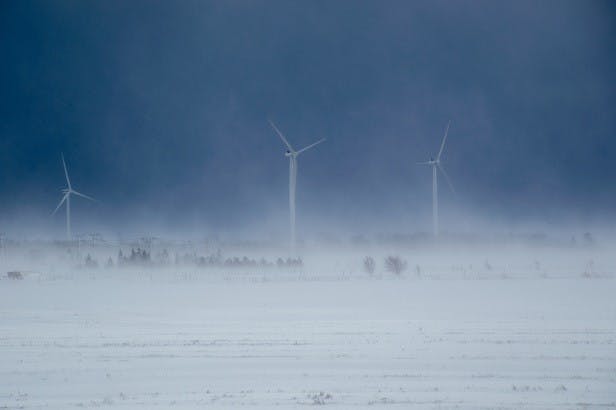 Wind turbines in a snow storm.