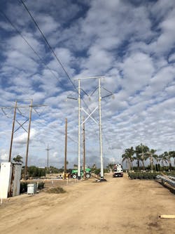 Prepping for stringing conductor on the 230kV H-frame structure. Prepping for stringing conductor on the 230kV H-frame structure.